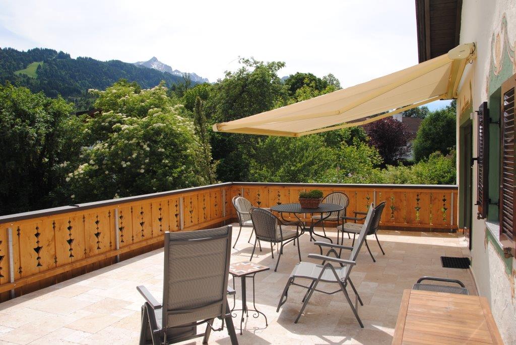 Summer terrace with awning and mountain view